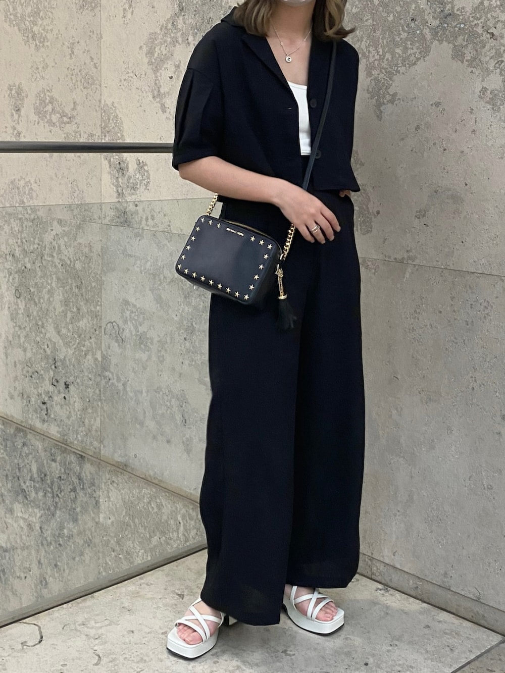 ブラック系のその他パンツ、ブラック系のテーラードジャケット、ホワイト系のキャミソールを着用したレディースの夏コーディネートの2枚目の写真