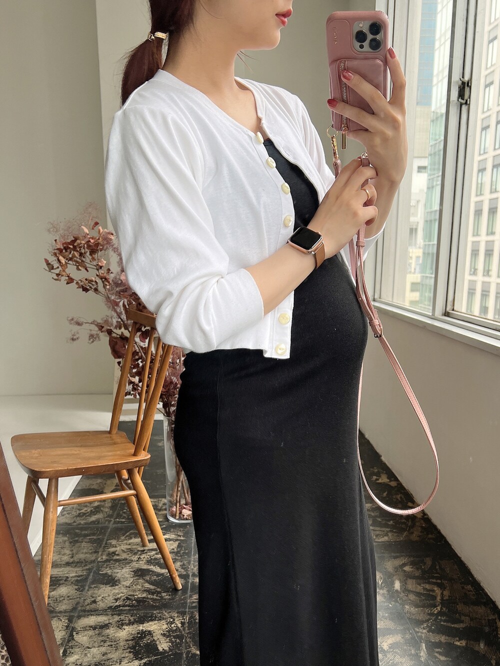 ブラック系のワンピース、ホワイト系のTシャツ/カットソー、ブラウン系のスマホケース/カバーを着用したレディースの夏コーディネートの2枚目の写真