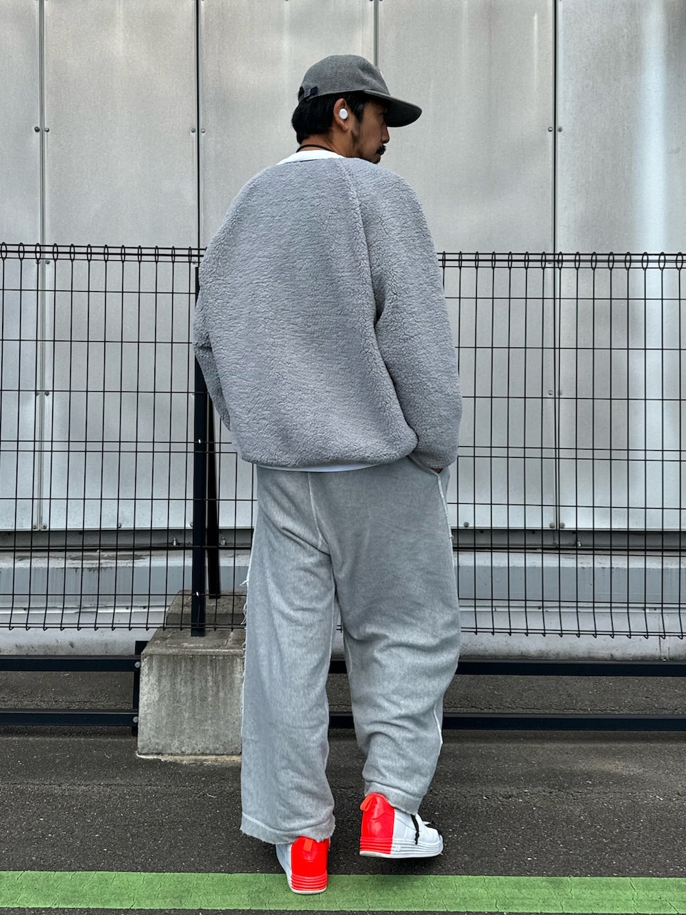 グレー系のブルゾン、ホワイト系のTシャツ/カットソー、グレー系のスウェットパンツを着用したメンズの秋コーディネートの5枚目の写真