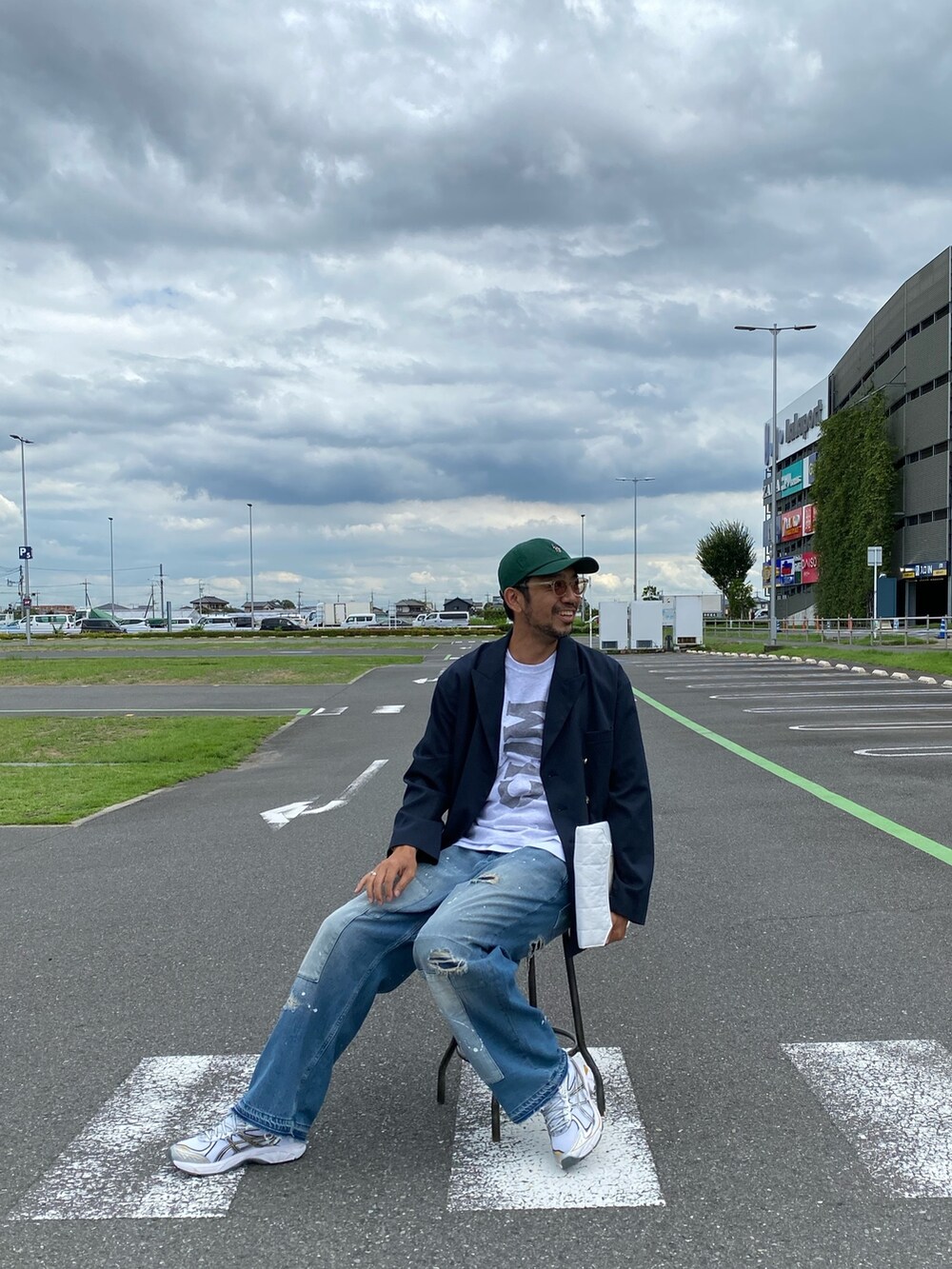 ブルー系のテーラードジャケット、グレー系のTシャツ/カットソー、ホワイト系のハンドバッグを着用したメンズの秋コーディネートの5枚目の写真