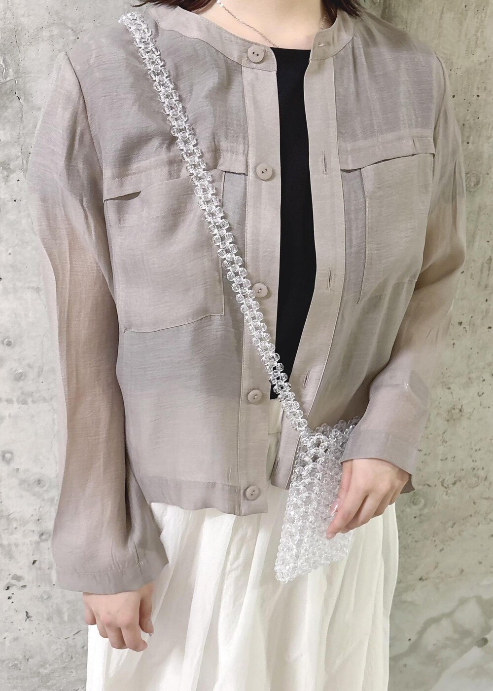 ホワイト系のスカート、ベージュ系のカーディガン/ボレロ、ブラック系のTシャツ/カットソーを着用したレディースの夏コーディネートの4枚目の写真