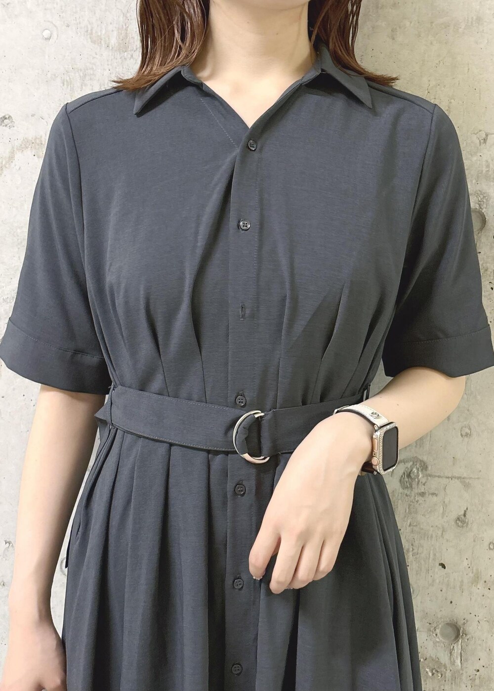 シルバー系のパンプス、グレー系のシャツワンピース、シルバー系のハンドバッグを着用したレディースの夏コーディネートの5枚目の写真