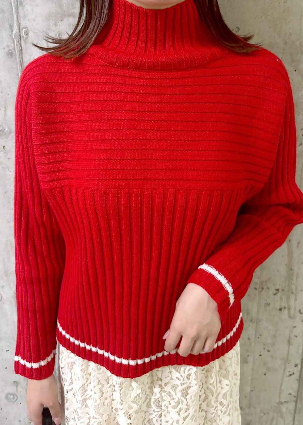 ホワイト系のスカート、レッド系のニット/セーター、グレー系のパンプスを着用したレディースの秋コーディネートの5枚目の写真