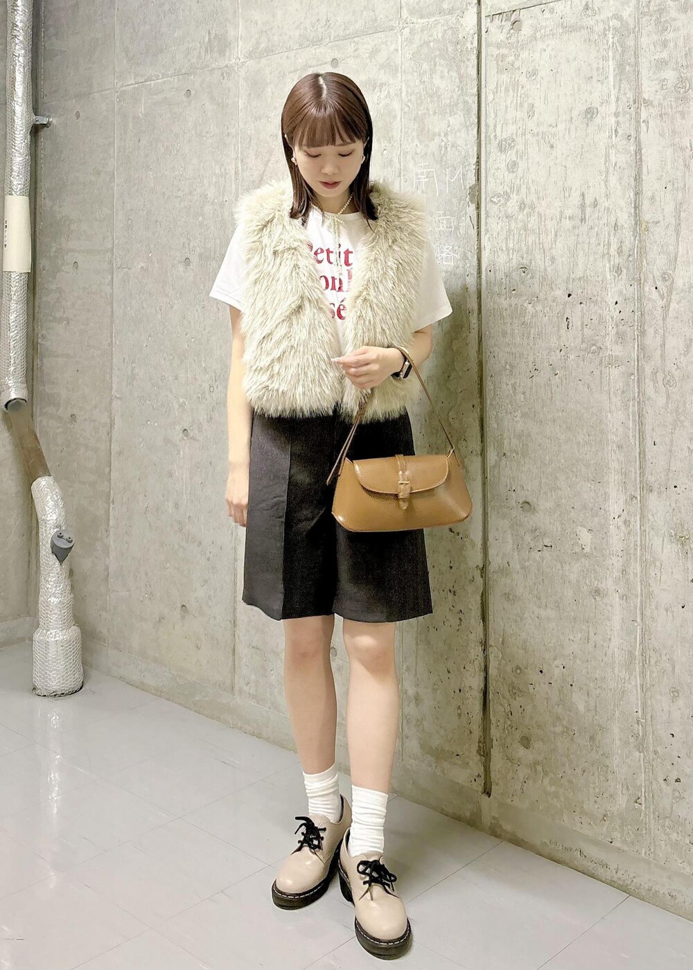 ベージュ系のベスト、ホワイト系のTシャツ/カットソー、ブラウン系のその他パンツを着用したレディースの秋コーディネートの4枚目の写真