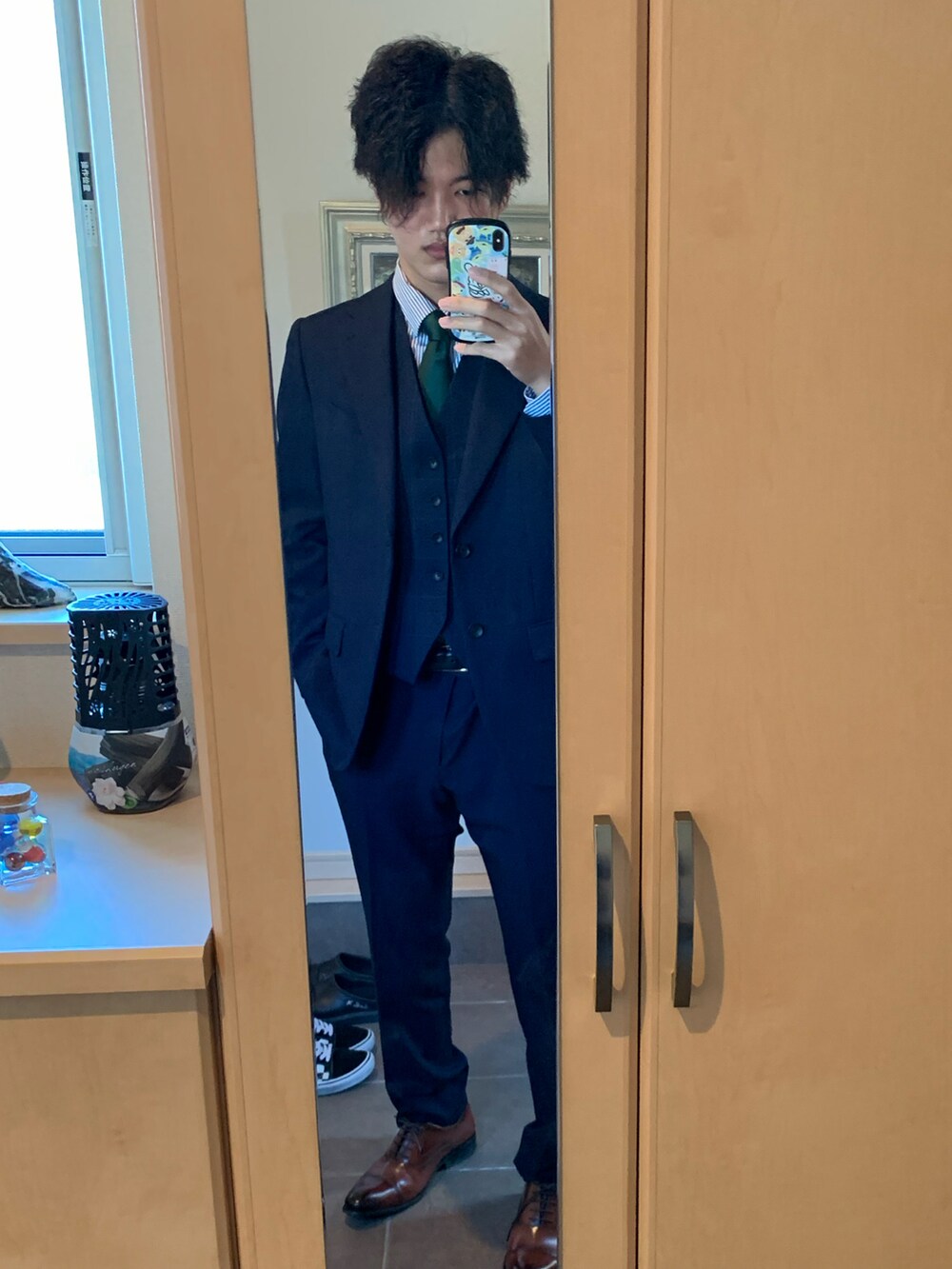 ブルー系のスーツパンツ、ブラウン系のドレスシューズ、ブルー系のスーツベストを着用したメンズの冬コーディネートの2枚目の写真