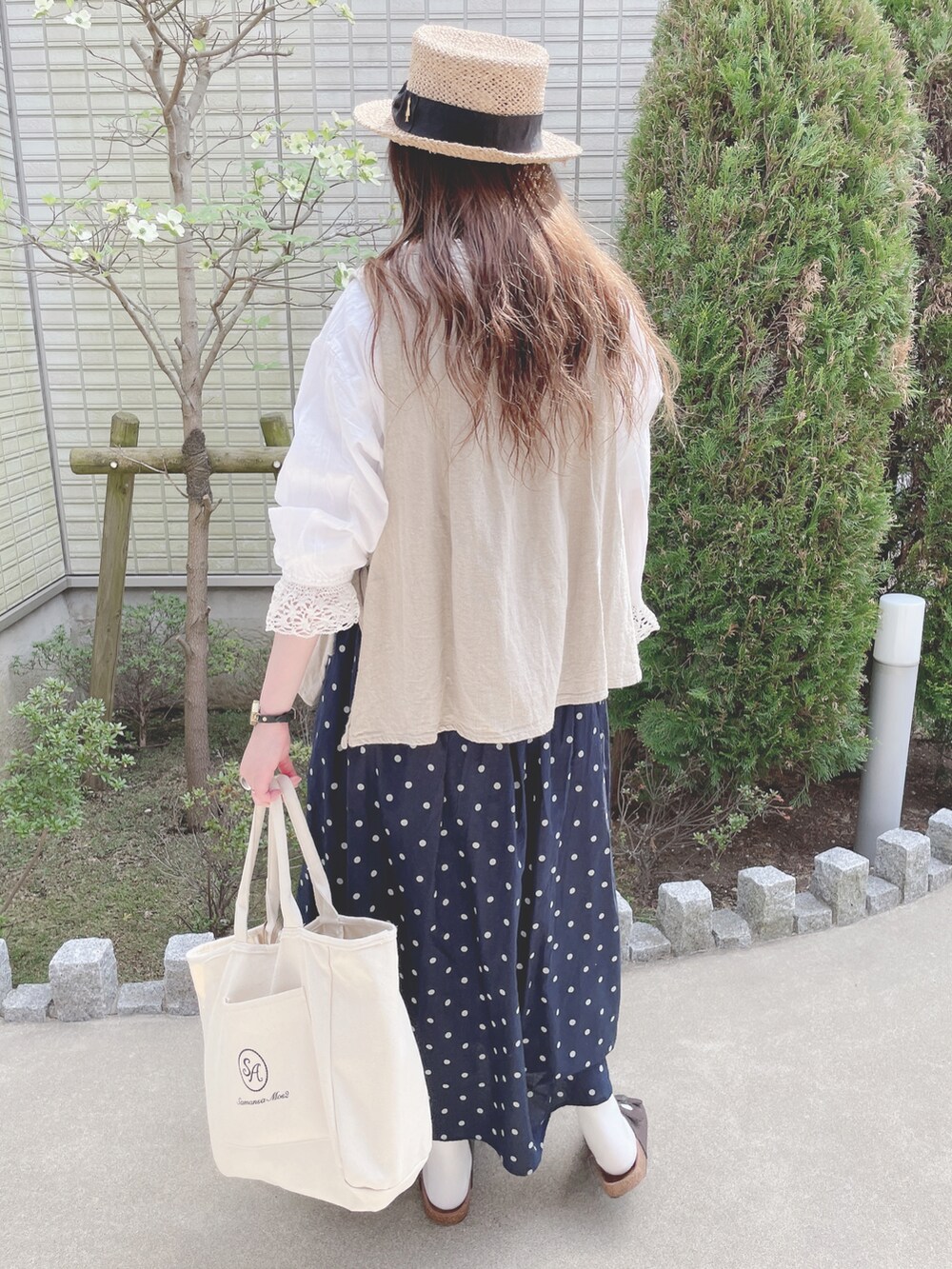 ホワイト系のシャツ/ブラウス、ベージュ系のトップス、ブルー系のスカートを着用したレディースの春コーディネートの3枚目の写真