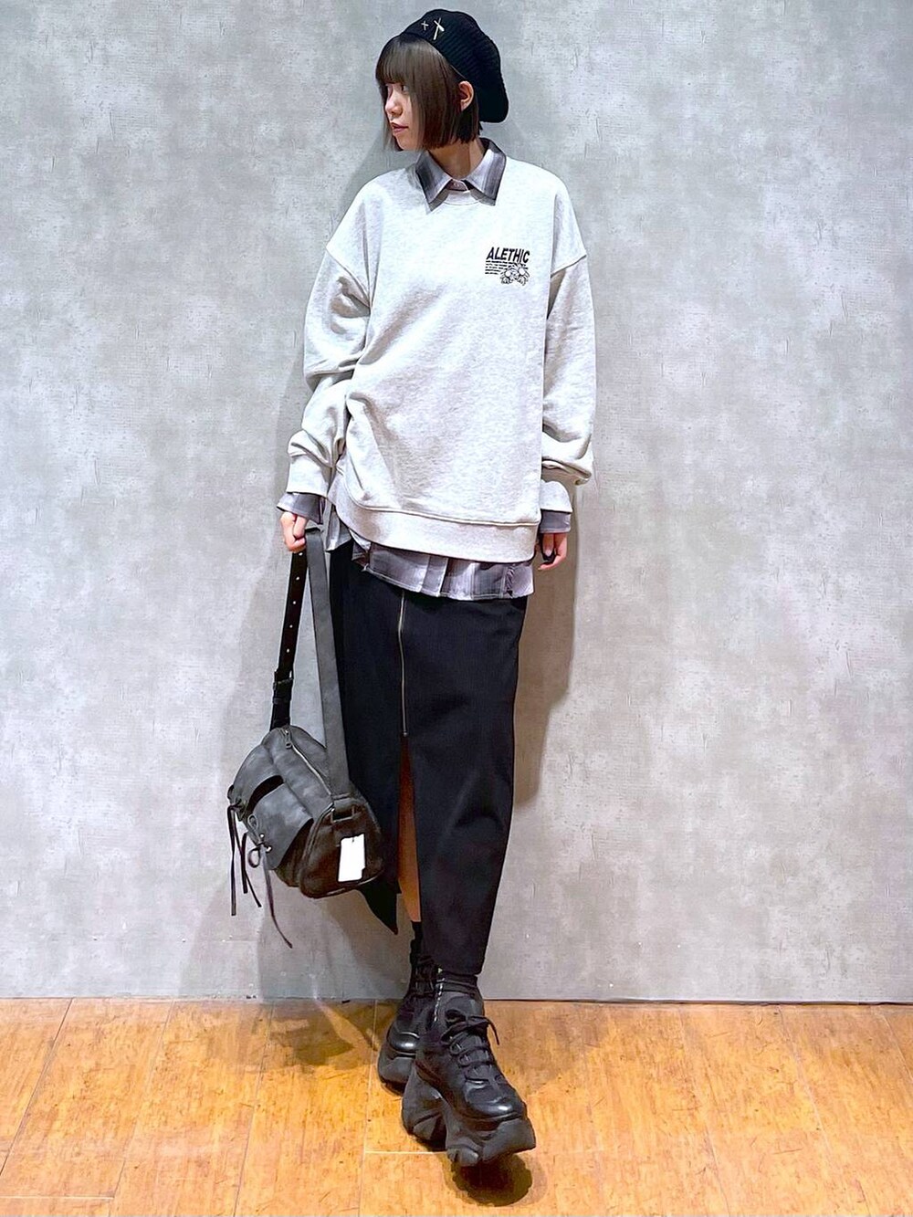 ブラック系のスニーカー、ブラック系のショルダーバッグ、グレー系のシャツ/ブラウスを着用したレディースの秋コーディネートの2枚目の写真