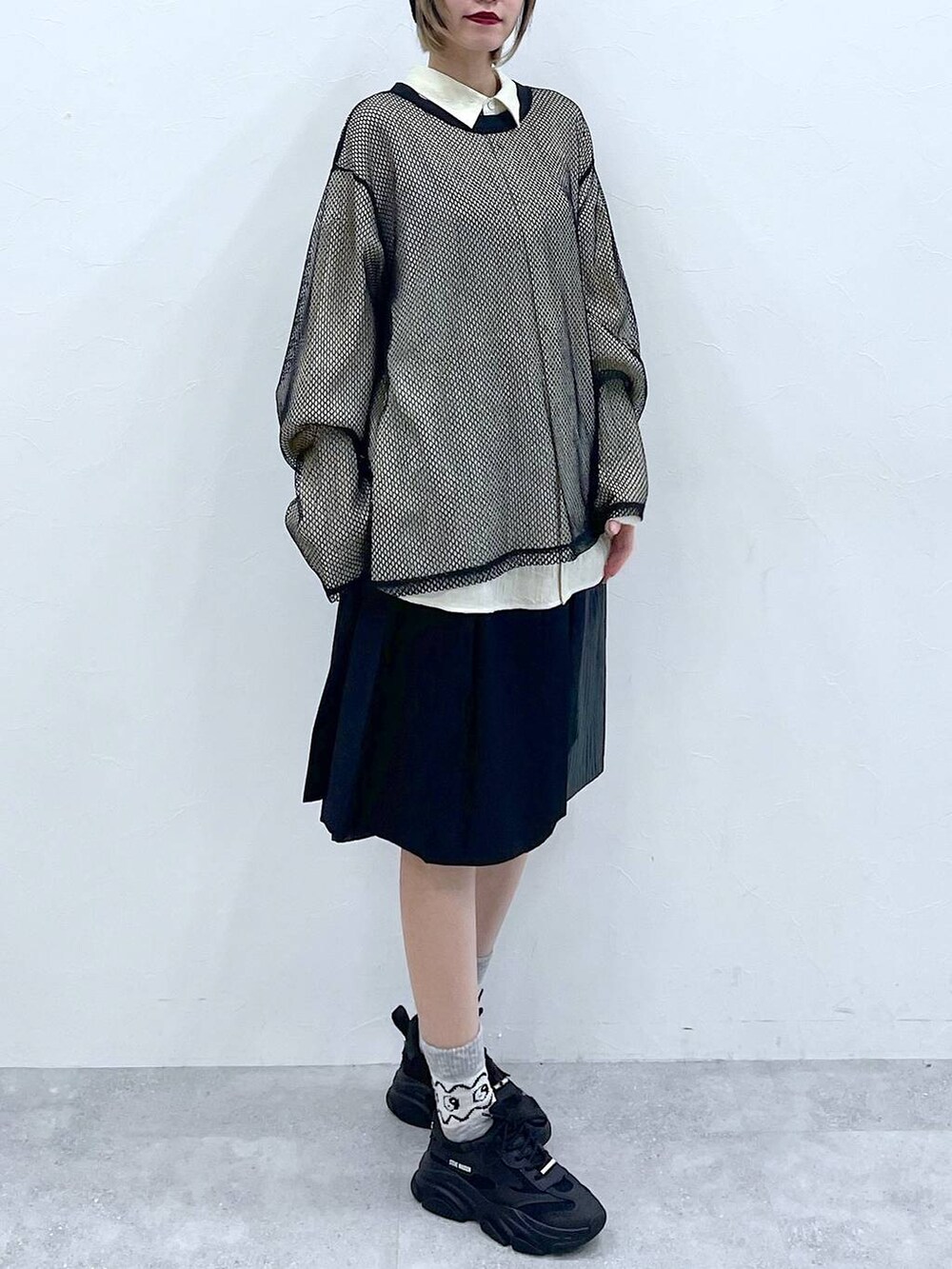 ブラック系のスラックス、ホワイト系のシャツ/ブラウス、ブラック系のTシャツ/カットソーを着用したレディースの冬コーディネートの3枚目の写真