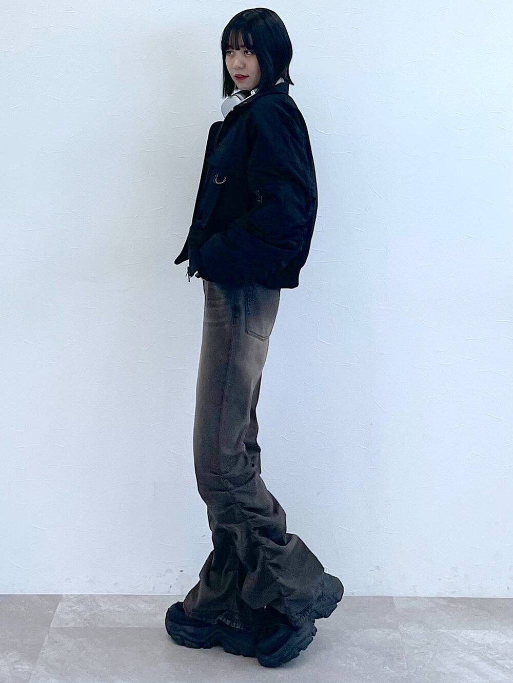 ブラック系のスニーカー、ブラック系のデニムパンツ、グレー系のTシャツ/カットソーを着用したレディースの秋コーディネートの6枚目の写真