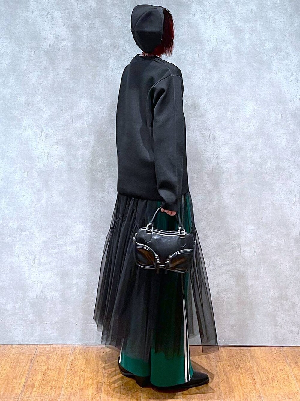 グリーン系のその他パンツ、ブラック系のニット/セーター、ブラック系のボストンバッグを着用したレディースの冬コーディネートの7枚目の写真