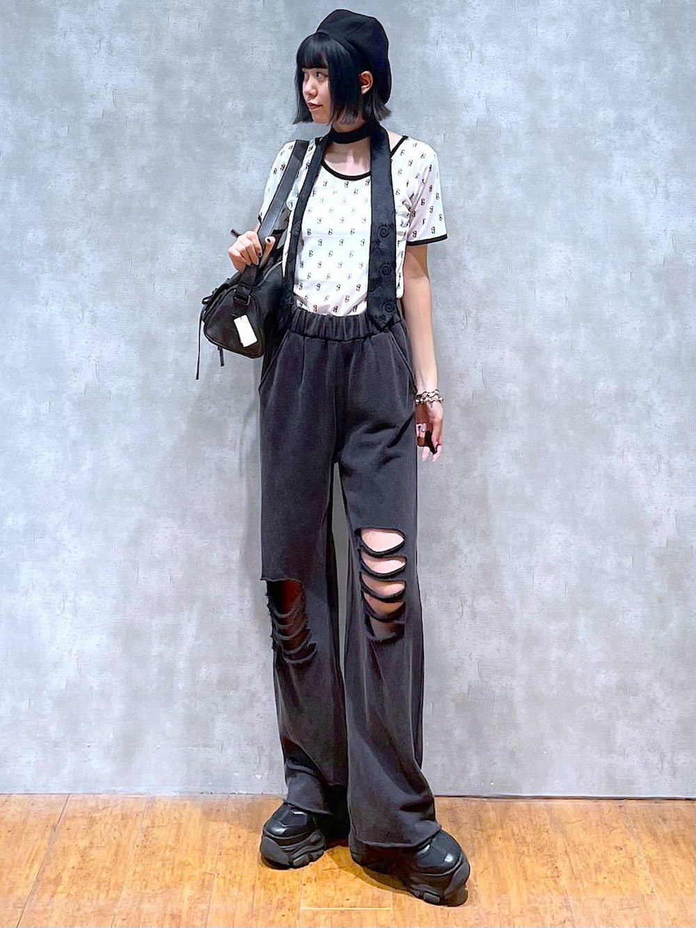 ブラック系のスニーカー、ブラック系のネクタイ、ブラック系のショルダーバッグを着用したレディースの夏コーディネートの3枚目の写真