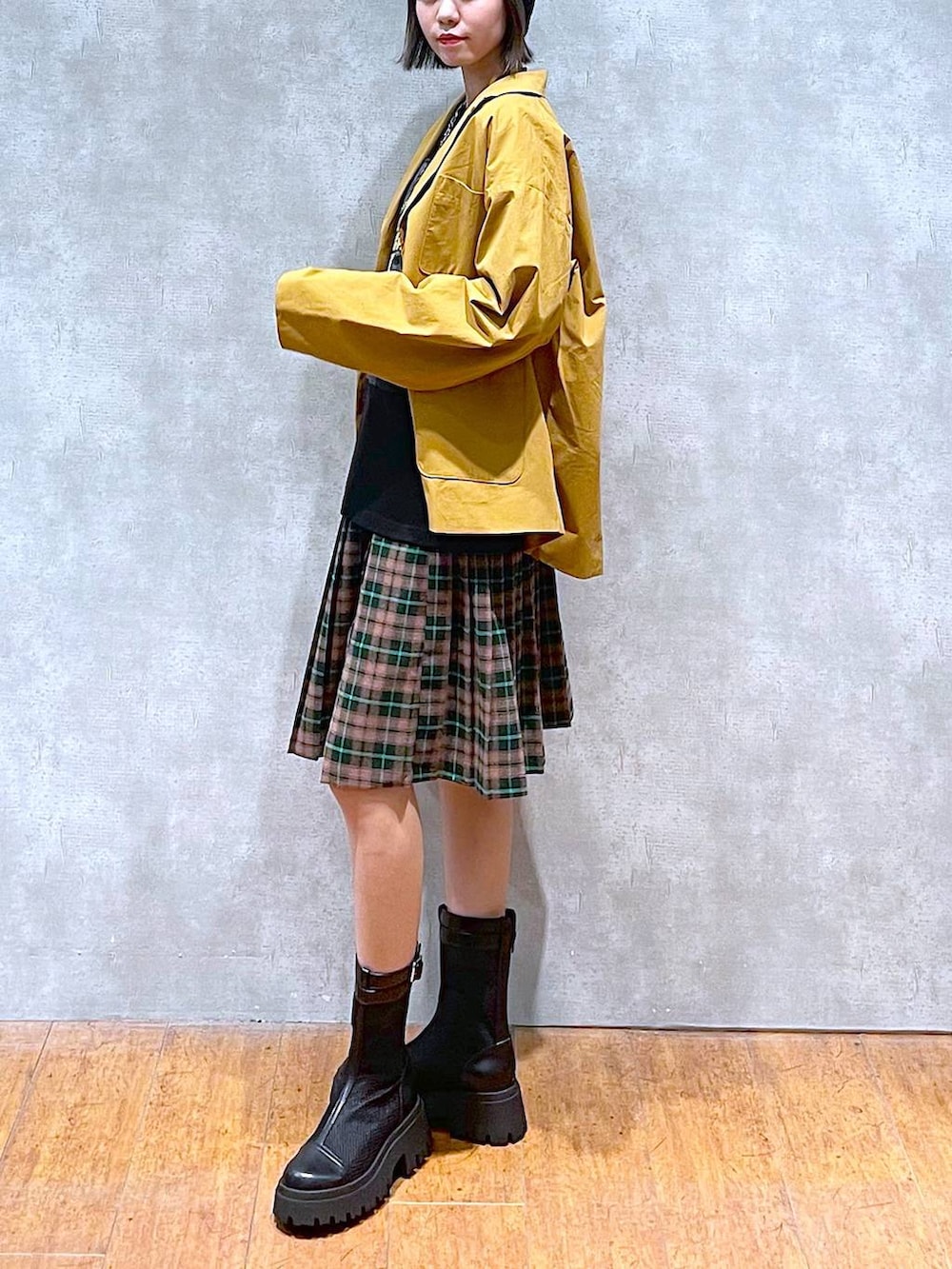 ブラック系のブーツ、ブラック系のショルダーバッグ、ブラック系のTシャツ/カットソーを着用したレディースの秋コーディネートの5枚目の写真