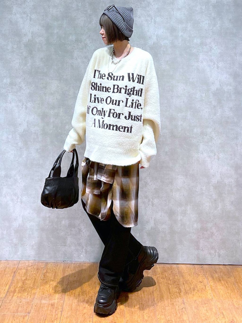 ブラック系のブーツ、イエロー系のシャツ/ブラウス、ホワイト系のニット/セーターを着用したレディースの秋コーディネートの3枚目の写真