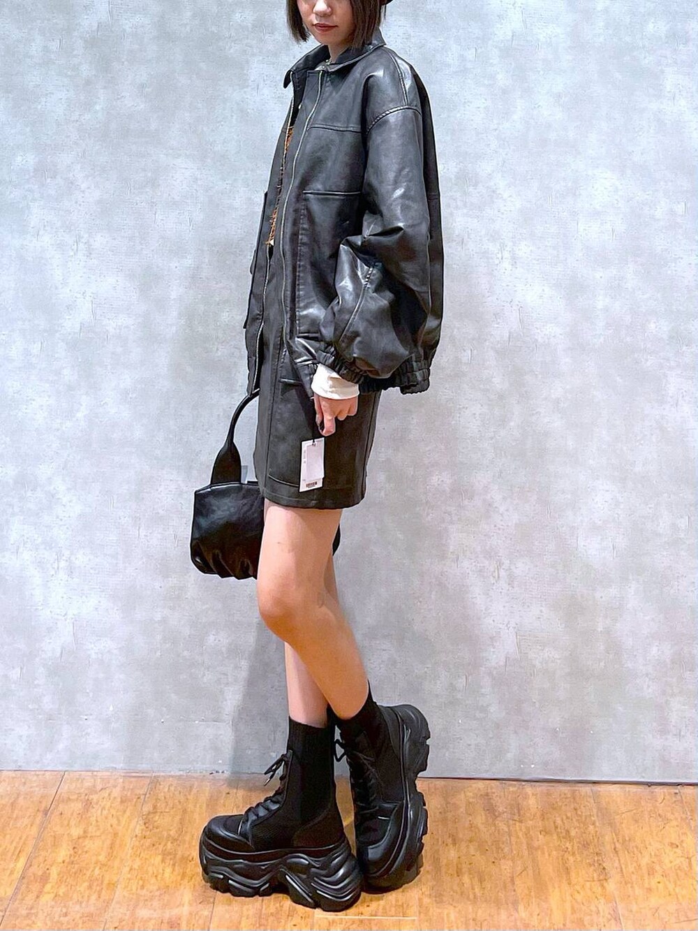 ブラック系のブーツ、ブラック系のブルゾン、ブラウン系のTシャツ/カットソーを着用したレディースの秋コーディネートの5枚目の写真
