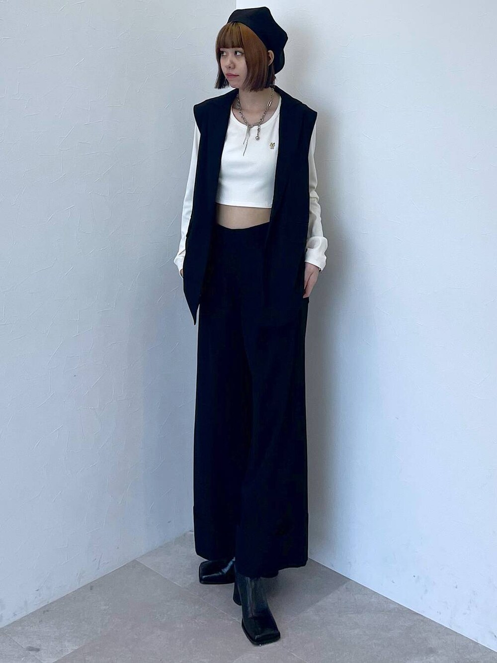 ブラック系のその他パンツ、ブラック系のベスト、ホワイト系のTシャツ/カットソーを着用したレディースの秋コーディネートの9枚目の写真