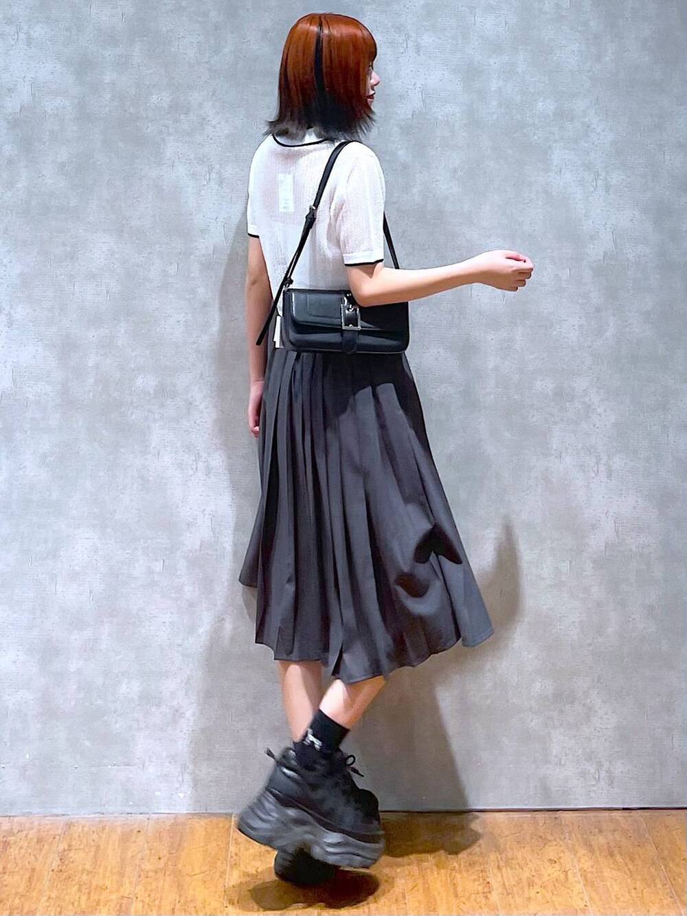 ブラック系のスニーカー、グレー系のスカート、ホワイト系のキャミソールを着用したレディースの夏コーディネートの5枚目の写真