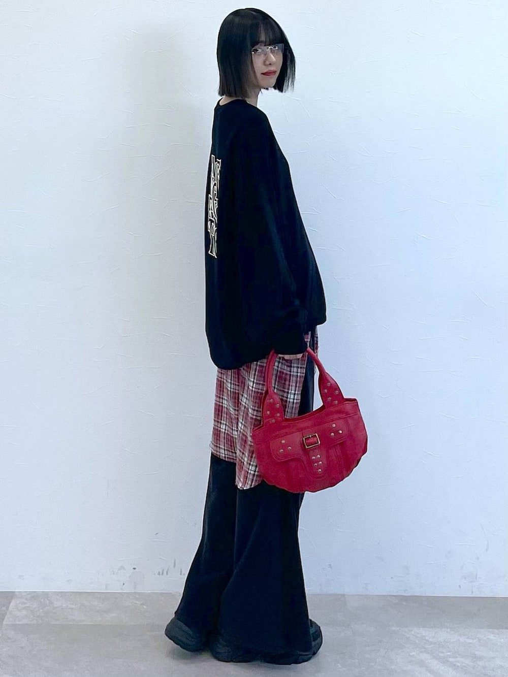 ブラック系のスニーカー、レッド系のシャツ/ブラウス、レッド系のハンドバッグを着用したレディースの秋コーディネートの5枚目の写真