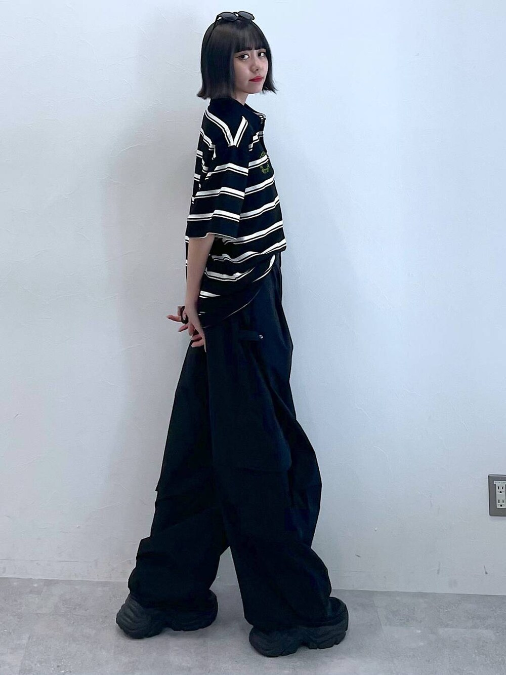 ブラック系のスニーカー、ブラック系のカーゴパンツ、ブラック系のTシャツ/カットソーを着用したレディースの夏コーディネートの5枚目の写真