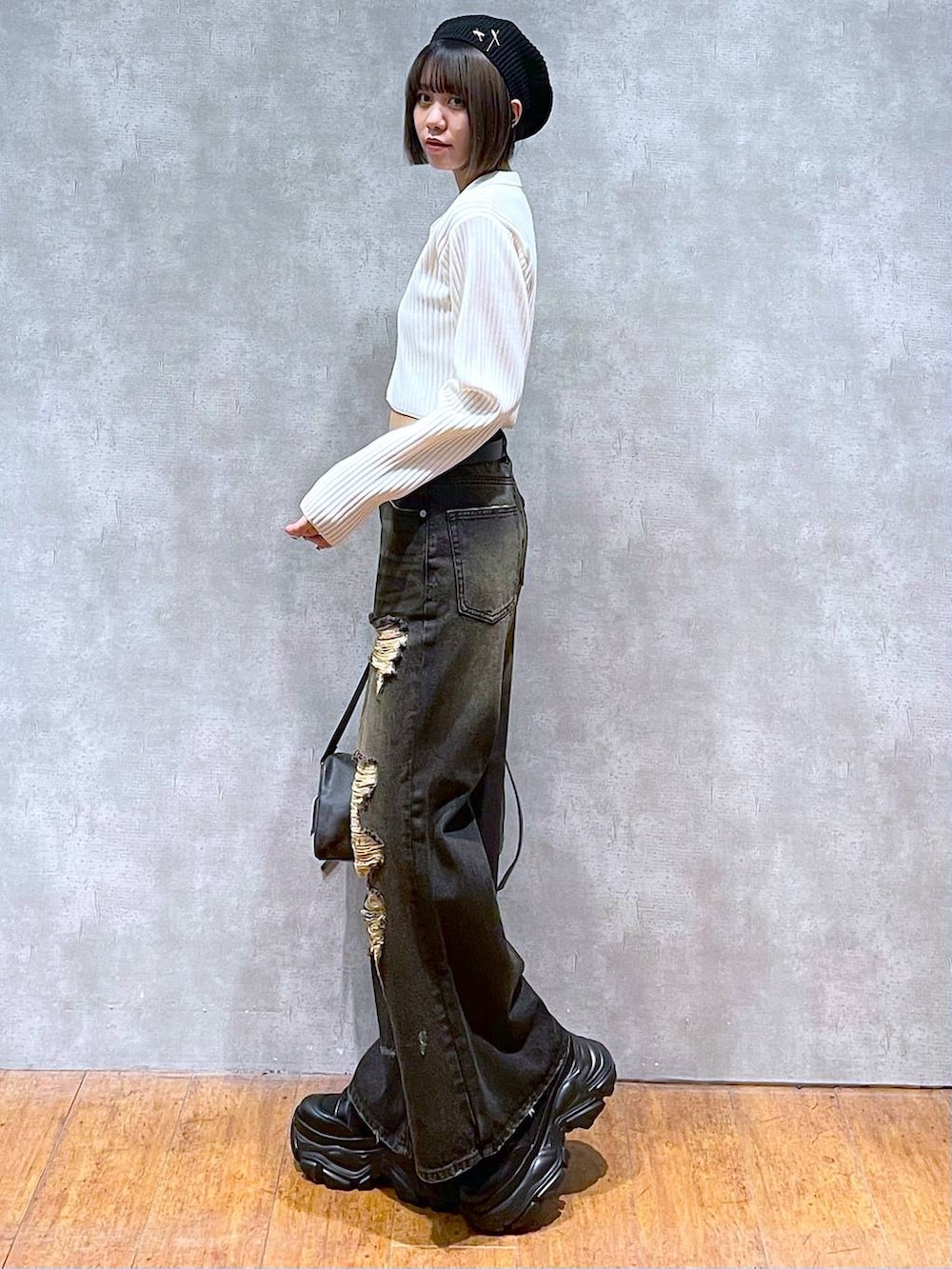 ブラック系のショルダーバッグ、ブラック系のブーツ、ブラック系のキャミソールを着用したレディースの秋コーディネートの7枚目の写真