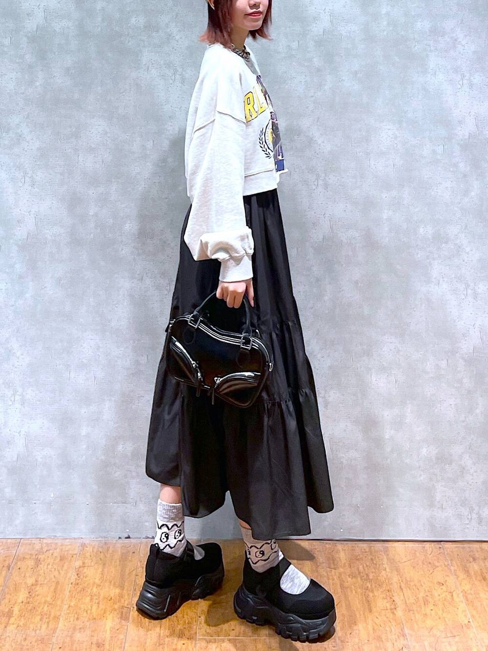 ベージュ系のスウェット、ブラック系のスニーカー、ブラック系のボストンバッグを着用したレディースの春コーディネートの3枚目の写真