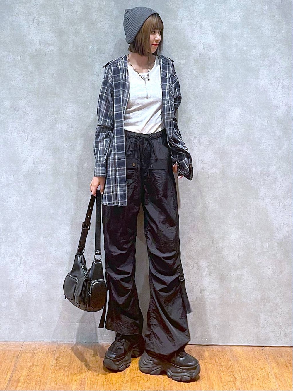 ブラック系のスニーカー、ブラック系のカーゴパンツ、ブルー系のシャツ/ブラウスを着用したレディースの秋コーディネートの6枚目の写真