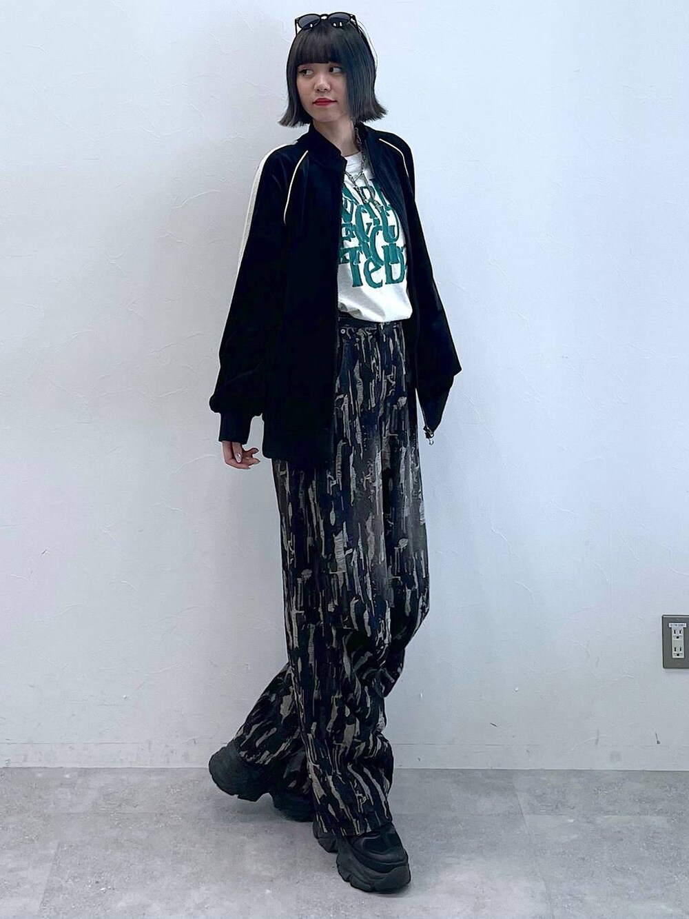 ブラック系のスニーカー、ブラック系のデニムパンツ、ブラック系のジャージを着用したレディースの秋コーディネートの7枚目の写真