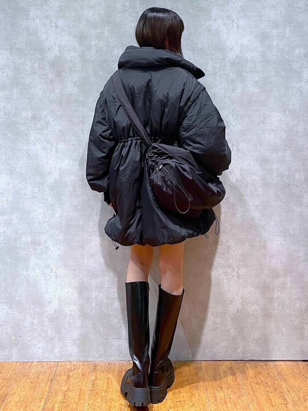 ブラック系のブルゾン、ブルー系のカーディガン/ボレロ、ブラック系のTシャツ/カットソーを着用したレディースの冬コーディネートの3枚目の写真