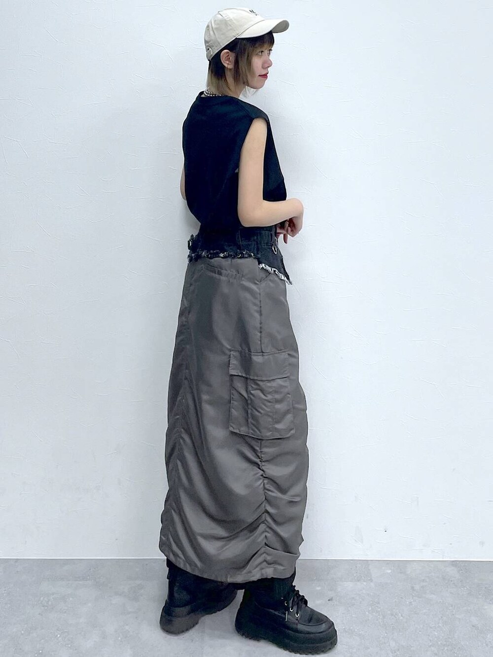 ブラック系のスラックス、ブラック系のTシャツ/カットソー、ブラック系のブーツを着用したレディースの春コーディネートの4枚目の写真