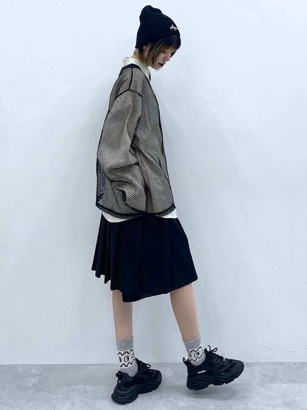 ブラック系のスラックス、ホワイト系のシャツ/ブラウス、ブラック系のTシャツ/カットソーを着用したレディースの冬コーディネートの4枚目の写真