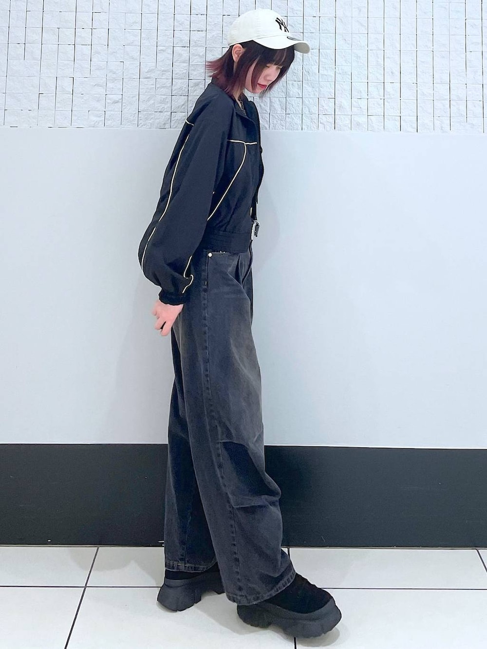 ブラック系のブルゾン、ブラック系のデニムパンツ、ブラック系のタンクトップを着用したレディースの春コーディネートの4枚目の写真