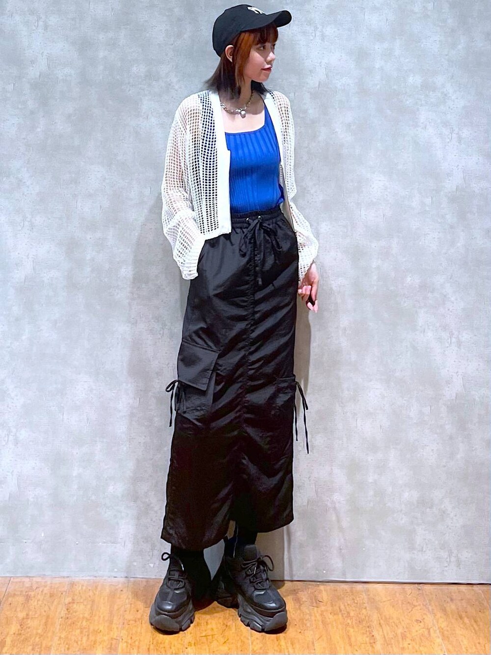 ホワイト系のカーディガン/ボレロ、ブルー系のタンクトップ、ブラック系のスニーカーを着用したレディースの夏コーディネートの2枚目の写真