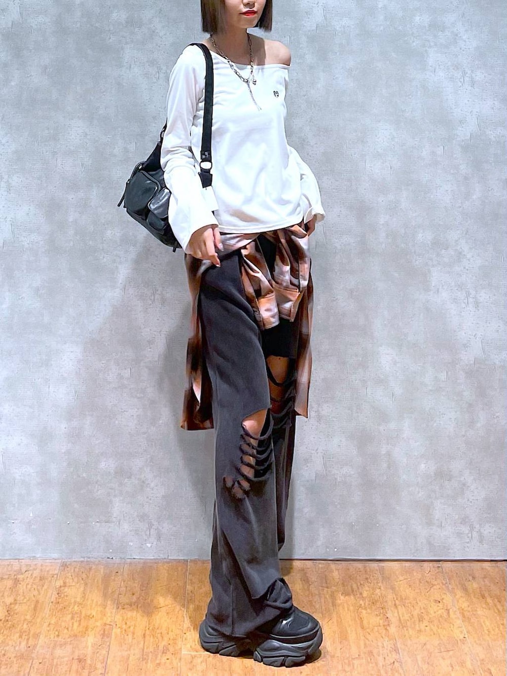 ブラック系のスニーカー、ブラック系のその他パンツ、オレンジ系のシャツ/ブラウスを着用したレディースの秋コーディネートの7枚目の写真