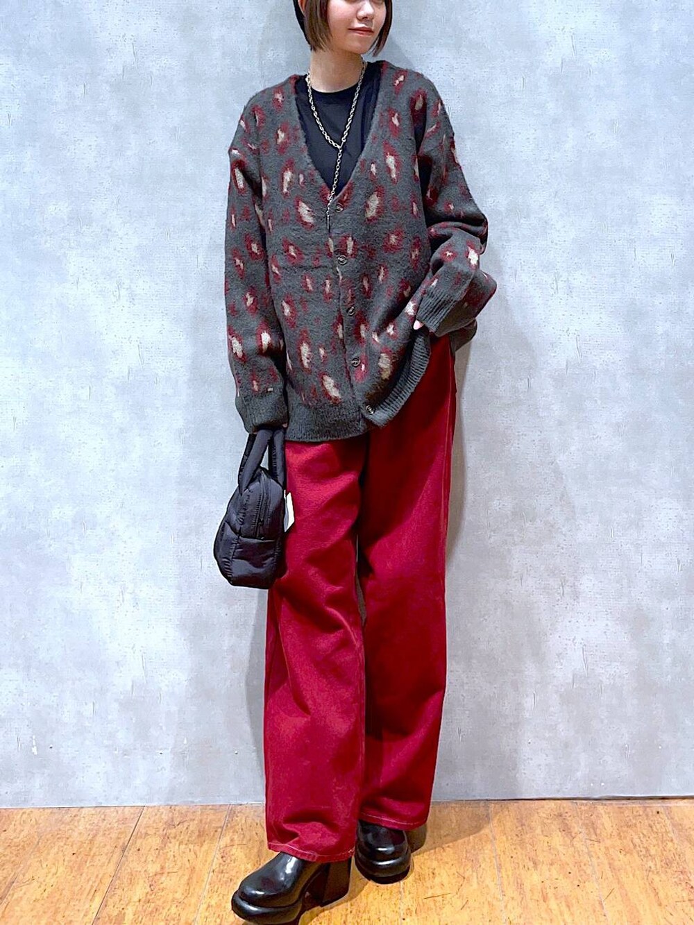 ブラック系のTシャツ/カットソー、レッド系のカーディガン/ボレロ、レッド系のその他パンツを着用したレディースの秋コーディネートの3枚目の写真