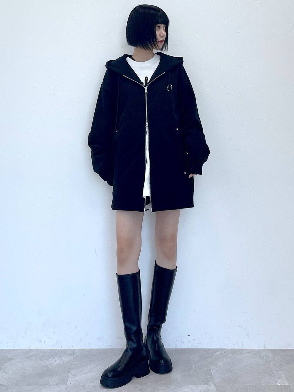 ブラック系のパーカー、ブラック系のブーツ、ブラック系のその他パンツを着用したレディースの冬コーディネートの5枚目の写真