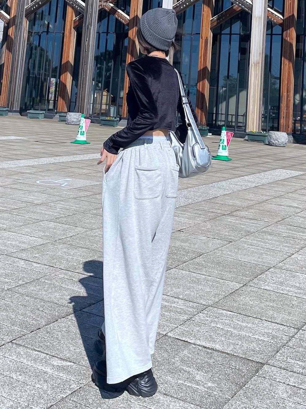 ブラック系のスニーカー、シルバー系のショルダーバッグ、ブラック系のTシャツ/カットソーを着用したレディースの秋コーディネートの5枚目の写真