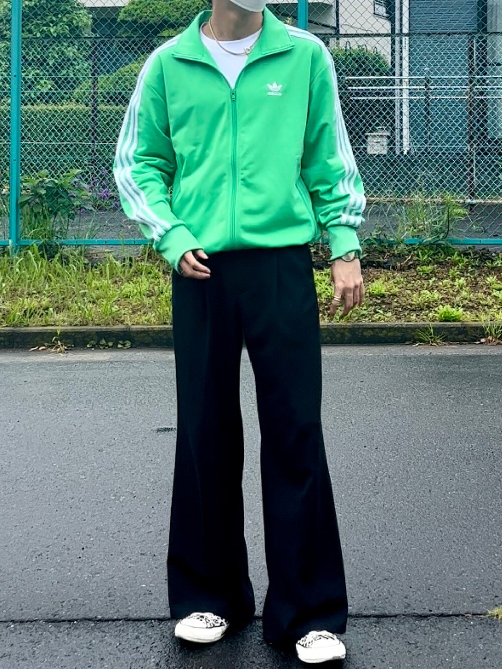 グリーン系のジャージ、ブラック系のその他パンツ、ホワイト系のスニーカーを着用したメンズの春コーディネートの2枚目の写真