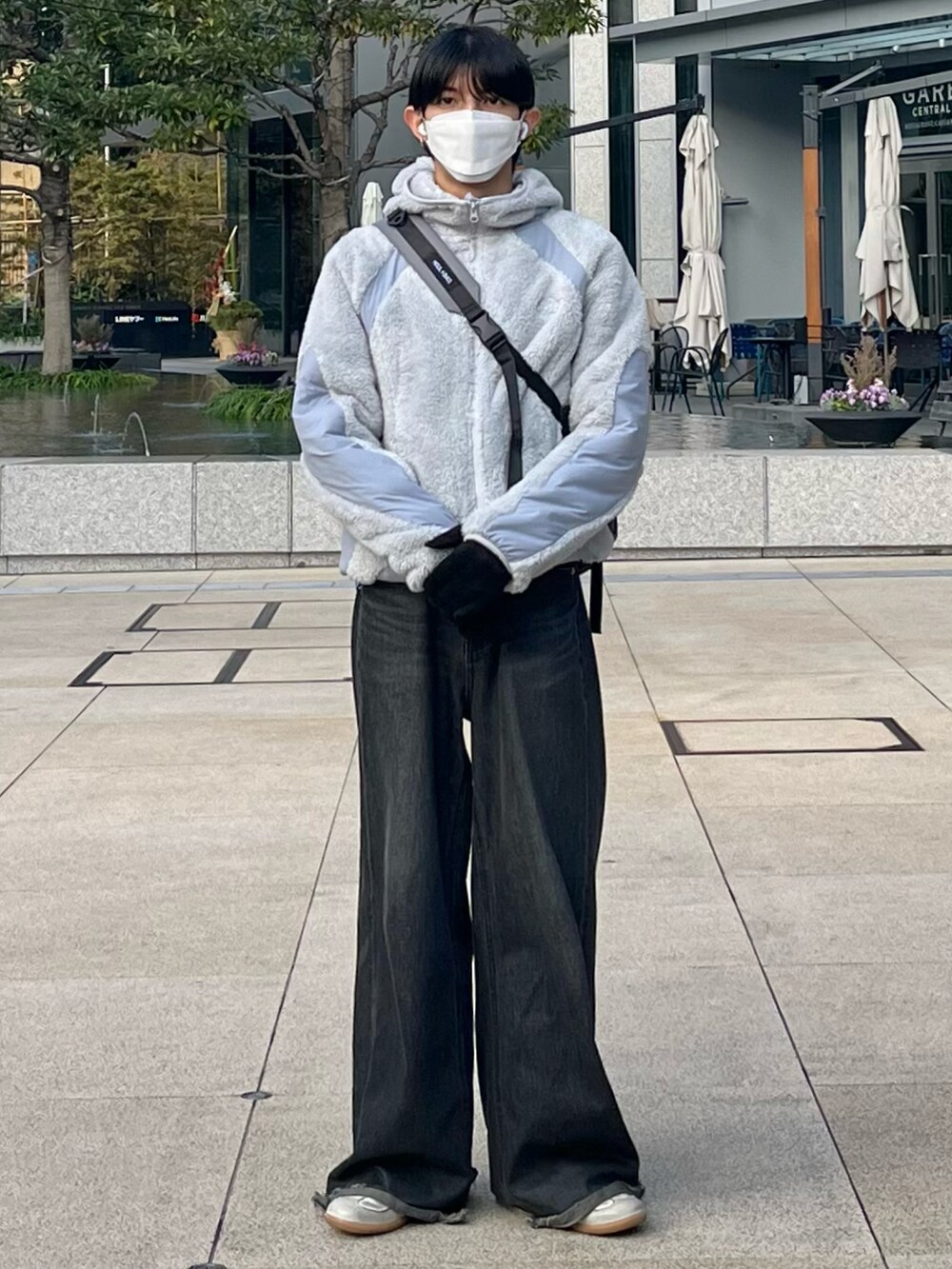 ブラック系のデニムパンツ、グレー系のその他アウター、グレー系のショルダーバッグを着用したメンズの冬コーディネートの3枚目の写真