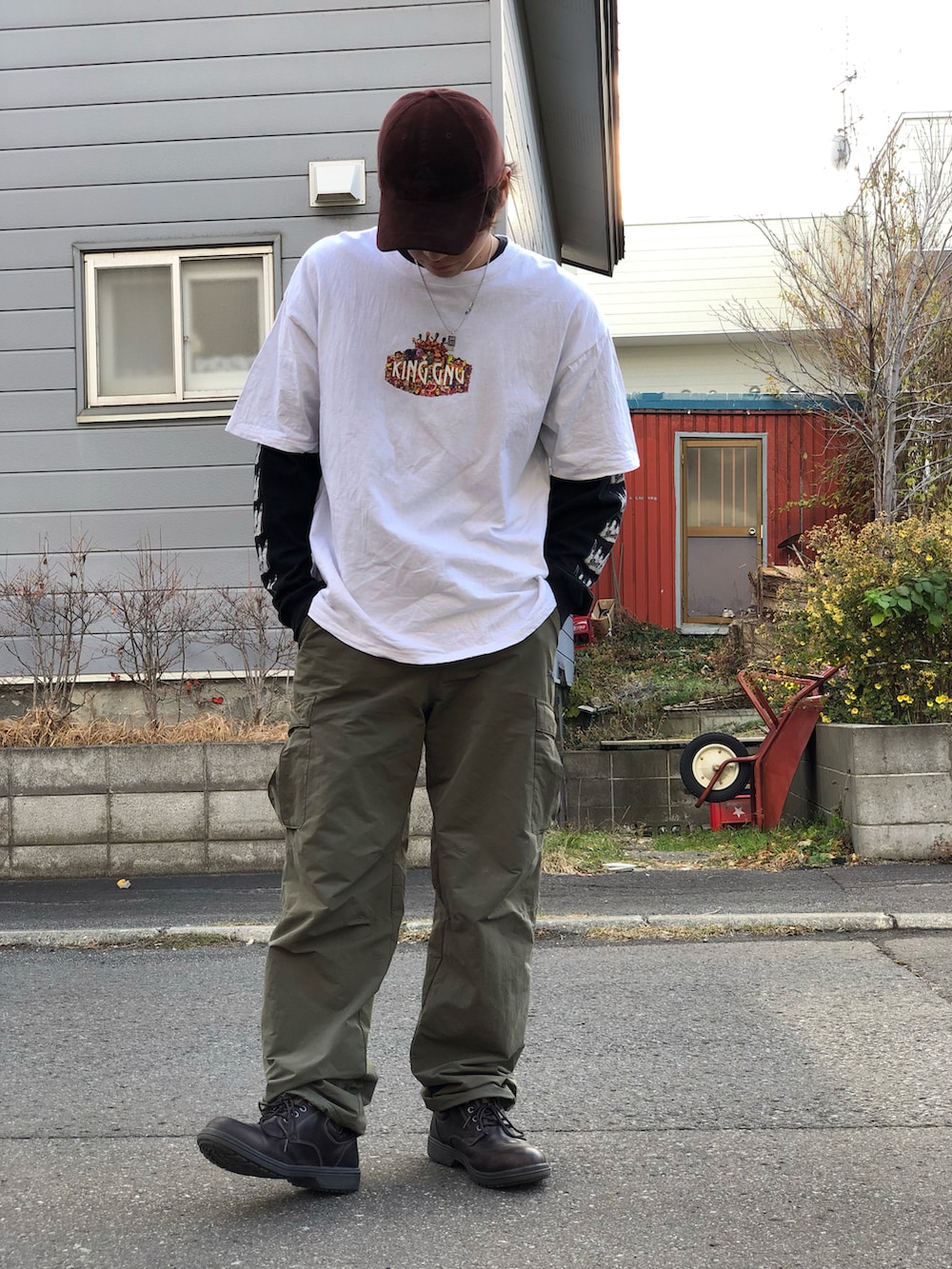 ブラウン系のブーツ、グリーン系のカーゴパンツ、ホワイト系のTシャツ/カットソーを着用したメンズの秋コーディネートの3枚目の写真