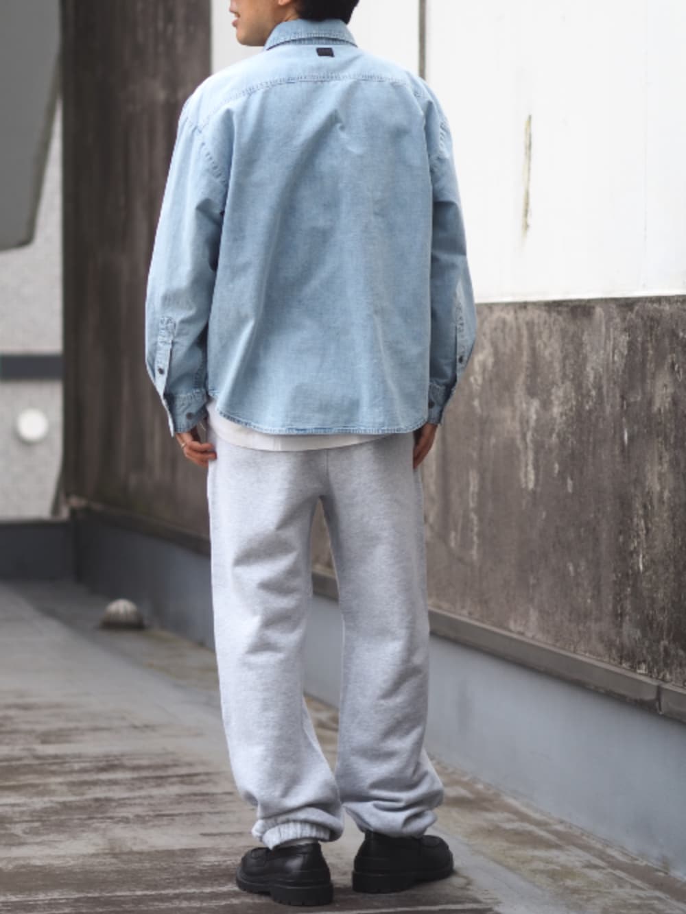 ブルー系のシャツ/ブラウス、グレー系のスウェットパンツ、ブラック系のローファーを着用したメンズの春コーディネートの2枚目の写真