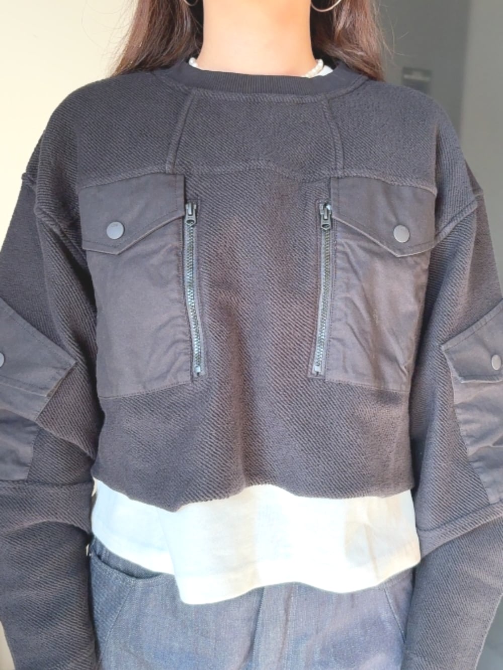 ブラック系のスウェット、ブルー系のデニムパンツを着用したレディースの秋コーディネートの2枚目の写真