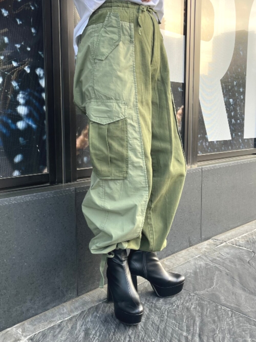 グリーン系のカーゴパンツ、ホワイト系のTシャツ/カットソーを着用したレディースの春コーディネートの2枚目の写真