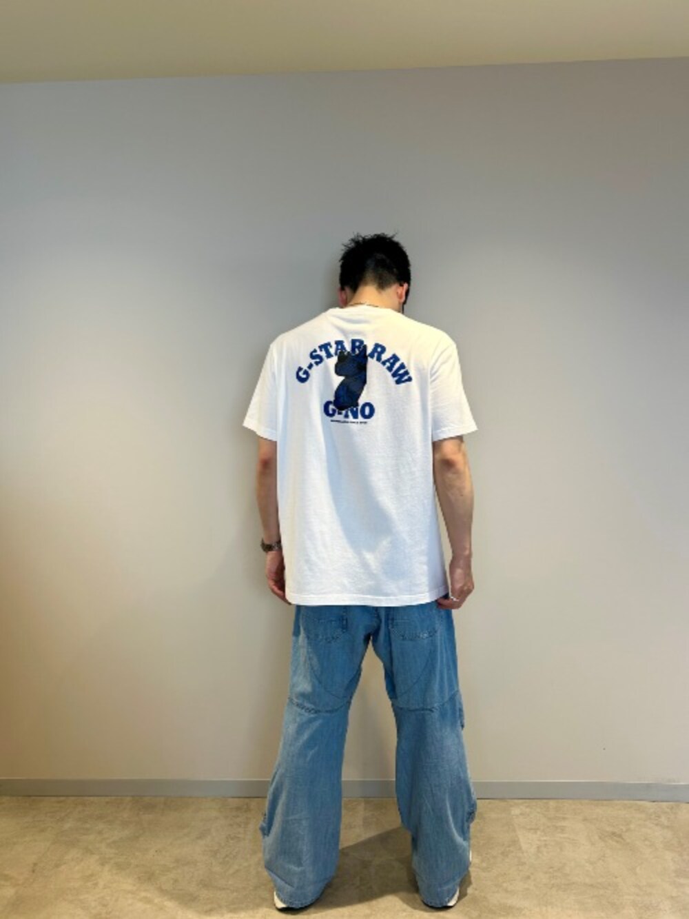 ホワイト系のTシャツ/カットソー、ブルー系のデニムパンツを着用したメンズの夏コーディネートの2枚目の写真
