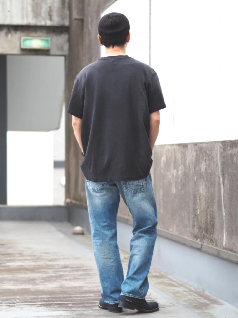 ブルー系のデニムパンツ、ブラック系のTシャツ/カットソーを着用したメンズの春コーディネートの2枚目の写真