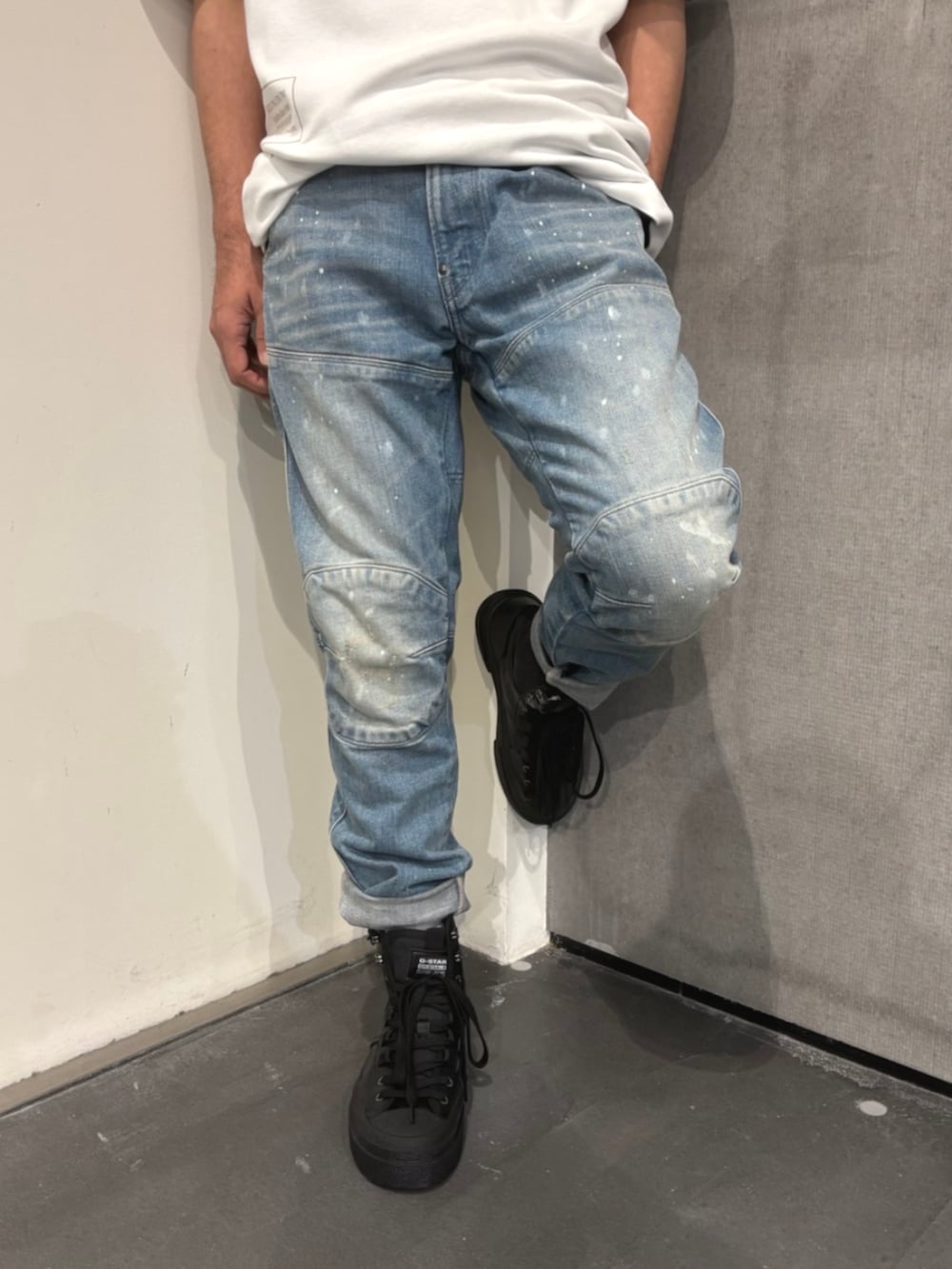 ホワイト系のTシャツ/カットソー、ブルー系のデニムパンツ、ブラック系のスニーカーを着用したメンズの夏コーディネートの3枚目の写真