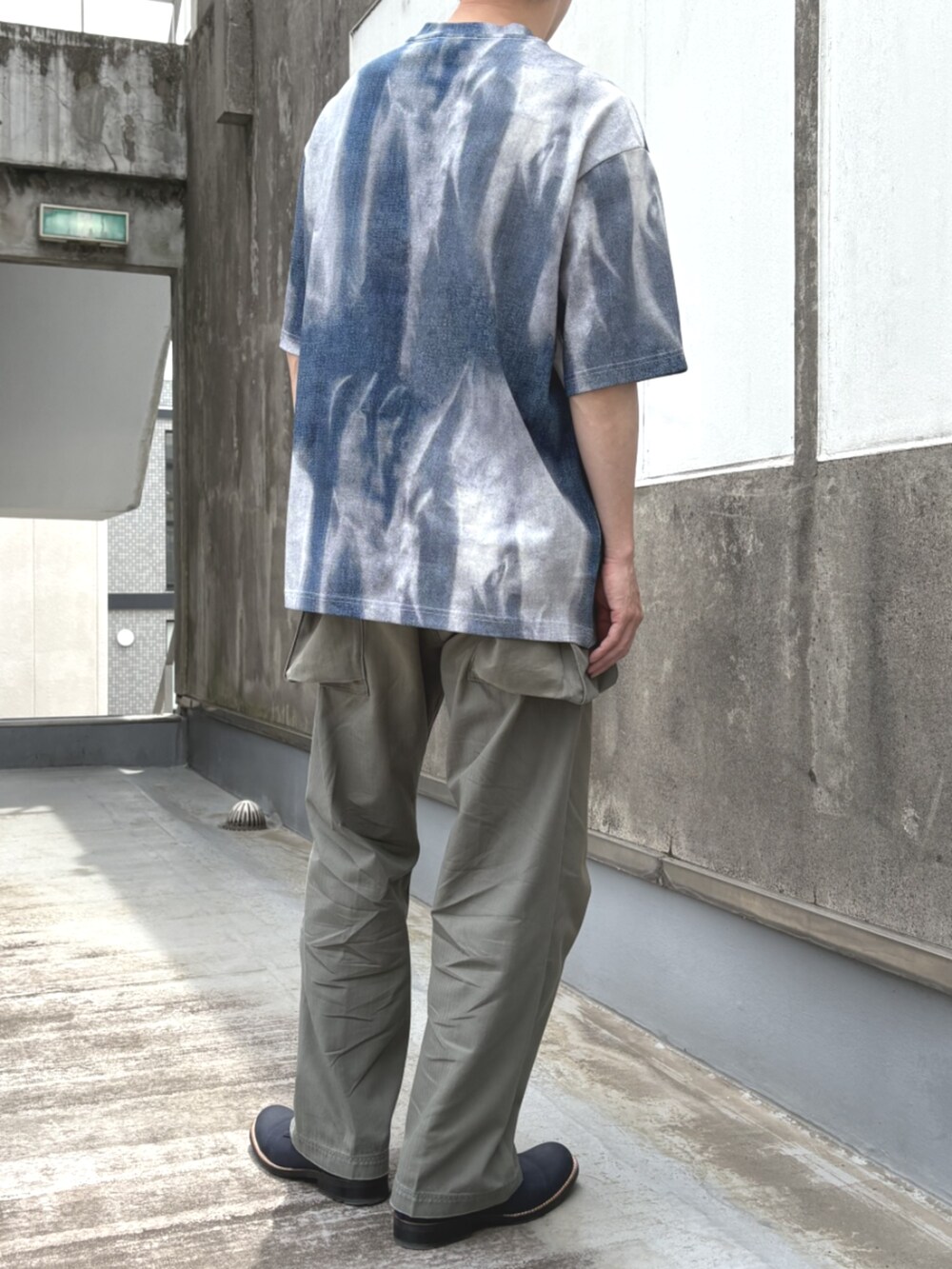 グリーン系のチノパンツ、ブルー系のTシャツ/カットソーを着用したメンズの夏コーディネートの2枚目の写真