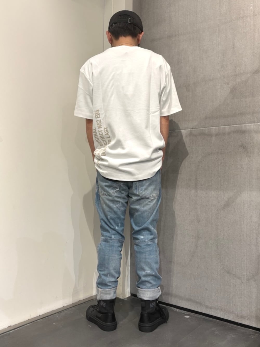 ホワイト系のTシャツ/カットソー、ブルー系のデニムパンツ、ブラック系のスニーカーを着用したメンズの夏コーディネートの2枚目の写真