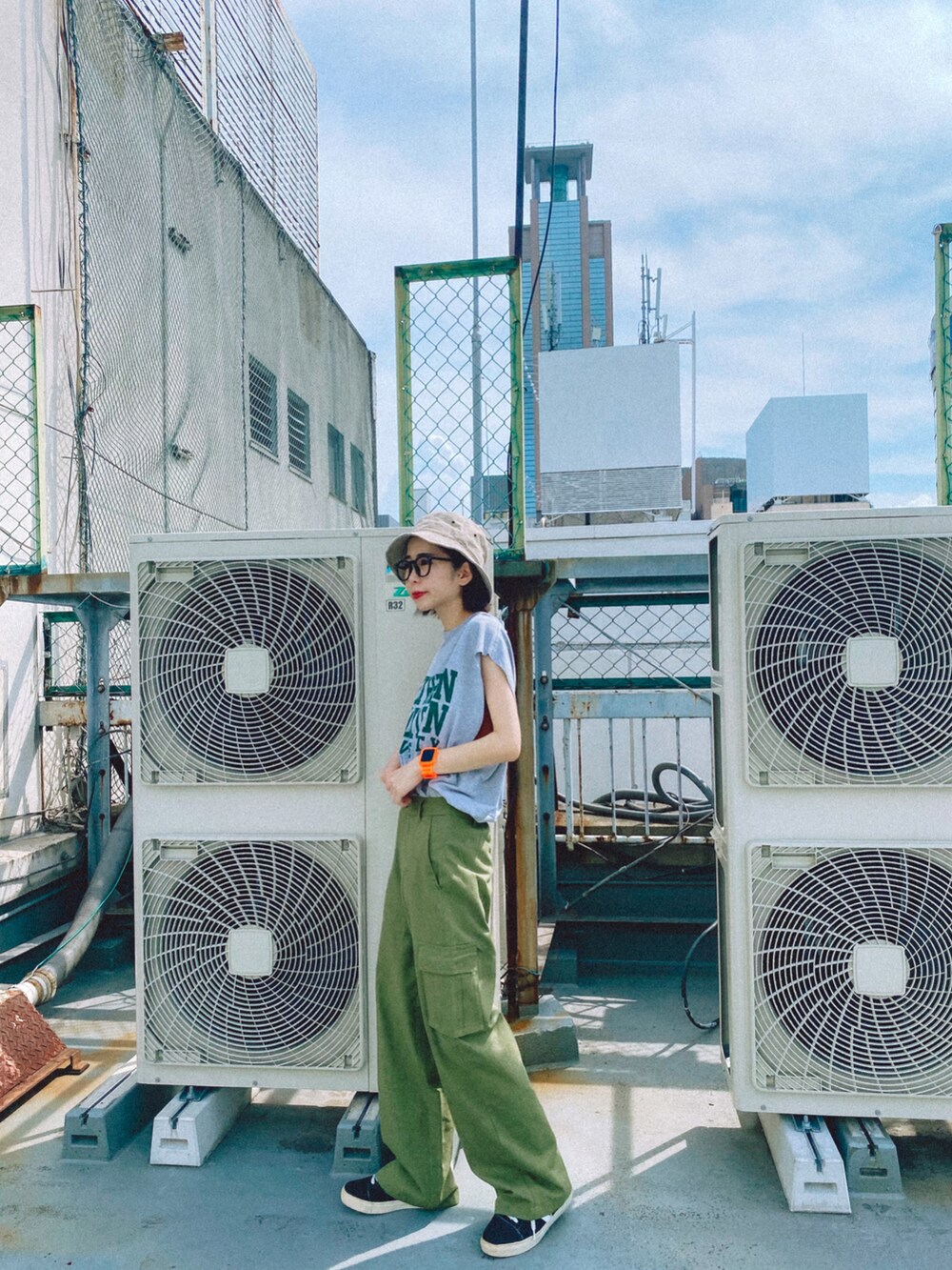 グリーン系のカーゴパンツを着用したレディースの夏コーディネートの3枚目の写真