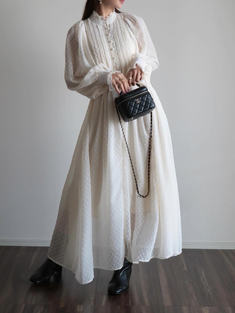 ホワイト系のワンピース、ベージュ系のキャップを着用したレディースの春コーディネートの5枚目の写真