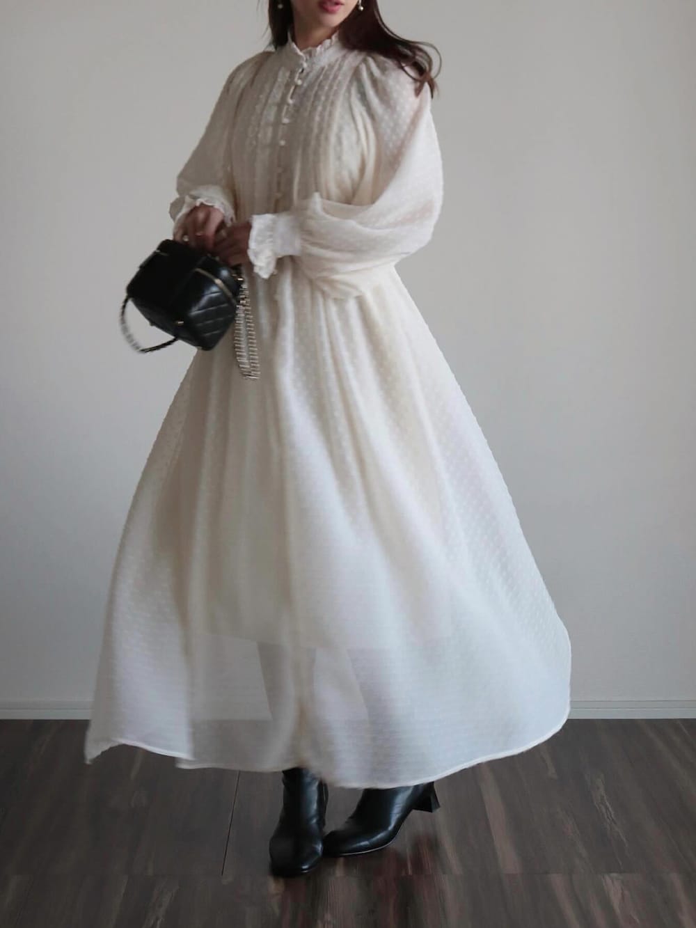 ホワイト系のワンピース、ベージュ系のキャップを着用したレディースの春コーディネートの3枚目の写真