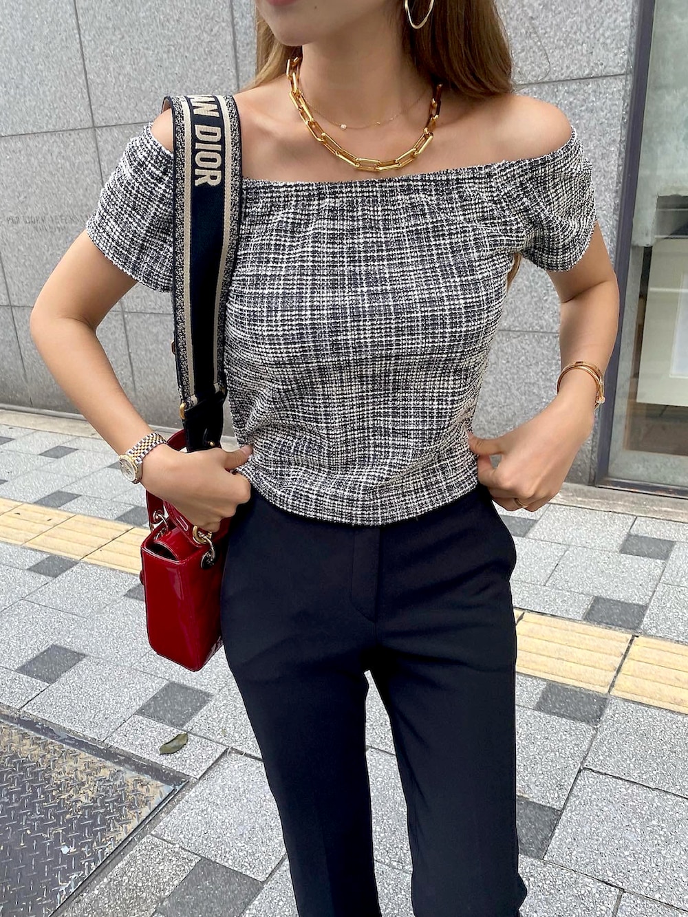 ブラック系のTシャツ/カットソー、レッド系のショルダーバッグ、ブラック系のスラックスを着用したレディースの夏コーディネートの2枚目の写真